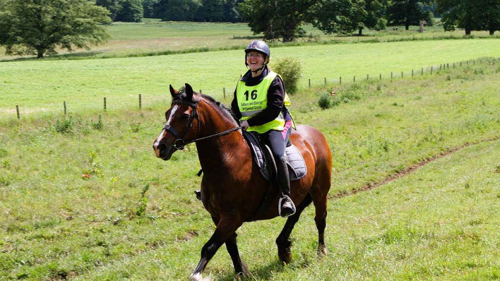 Horse rider laughing in field