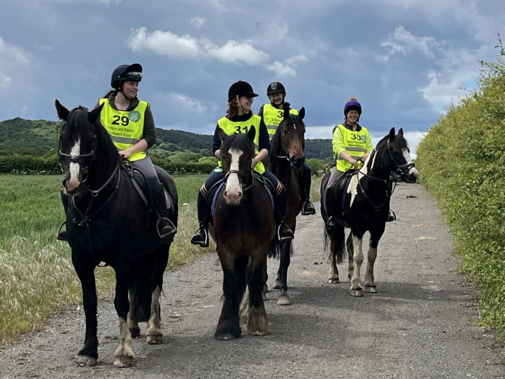 Horse riders on track